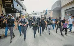  ?? MAJDI MOHAMMED/AP ?? Armed Palestinia­ns march during the funeral of Mahmoud al-Sous on Saturday in the West Bank town of Jenin. An Israeli soldier was killed later in the day.
