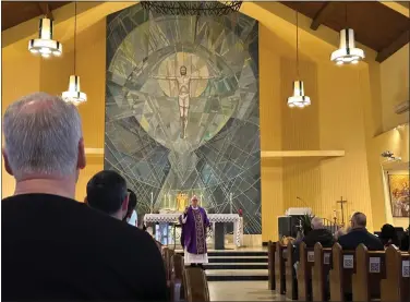 ?? EMMA RALLS — MEDIANEWS GROUP ?? Father Jim O’Rourke led the Wednesday morning mass on Ash Wednesday at St. Clement’s Church.