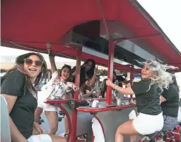  ?? MEG POTTER/THE REPUBLIC ?? A bacheloret­te party rides to Old Town bars on a party bike in Scottsdale on April 3.