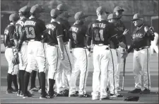  ?? JEREMY STEWART / RN-T staff ?? Rome Braves manager Rocket Wheeler (right) talks to players and coaches during a preseason workout on Tuesday.