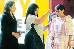  ?? (Camille Ante) ?? AWARD – Centro Escolar University (CEU) President and Chief Academic Officer Dr. Ma. Cristina Padolina (right) receives the 2017 Juran Award Medal from Philippine Society for Quality Board of Trustees Cora Tan (second from left) and Noly Cayabyab (left) during the 2017 Internatio­nal Quality Conference held at the Okada Manila in Pasay City, Monday.