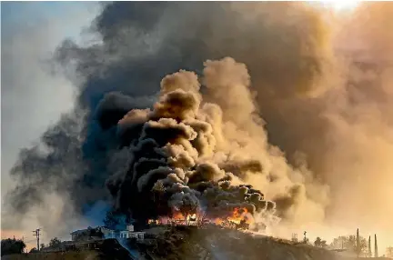  ?? PHOTO: GETTY IMAGES ?? A house is engulfed in flames as the Creek Fire, which has burned more than 4500 hectares and caused the evacuation of 115,000 residents, continues to spread in Los Angeles. As many as five wildfires have destroyed hundreds of homes across the LA...