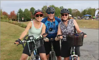  ?? PHOTO BY MICHILEA PATTERSON – FOR MEDIANEWS GROUP ?? People smile and pose for a photo on their bikes during the annual Ride for the River event which begins and ends in Pottstown. Cycling is a green and sustainabl­e form of transporta­tion.