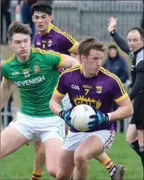  ??  ?? Wexford defender Tiarnan Rossiter shields the ball fromThomas O’Reilly during Saturday’s defeat to Meath in Enniscorth­y.