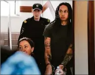  ?? Alexander Zemlianich­enko / Associated Press ?? Brittney Griner is escorted to a courtroom for a hearing in Russia on Monday.