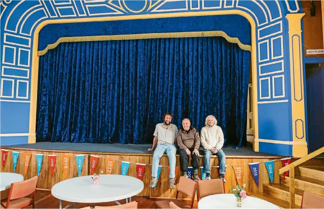  ?? PHOTO: DAVID JAMES/STUFF ?? Rick Edmonds, Ian Cameron and Pip Maslen sit on stage at the Havelock Town Hall. Money raised from plays at the hall go back into its upkeep and restoratio­n.