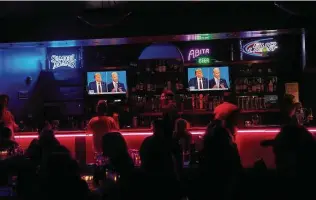  ?? Bridget Bennett / New York Times ?? Bar patrons watch the first debate between nondrinker­s President Donald Trump and former Vice President Joe Biden in Las Vegas in September.