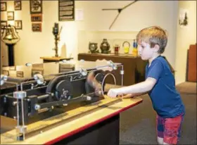  ?? PHOTOS BY ANITA T ORENICK ?? “All Aboard! The Science of Trains,” an exhibit at the Great Lakes Science Center in Cleveland, is chock full of hands-on stations.