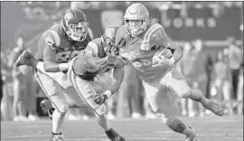  ?? Wally Skalij Los Angeles Times ?? JOSHUA KELLEY gains some of his 289 yards at the Rose Bowl despite being grabbed by USC linebacker John Houston during the second quarter.