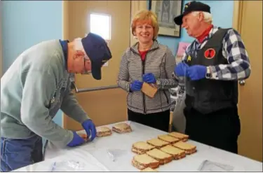  ??  ?? Above, Sen. Judy Schwank joined Bill Lutz and the Oley American Legion Post 878 to make lunches for Hope Rescue Mission of Reading. Left, Legion member Bill Lutz unloads the bread for sandwich making.