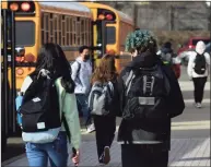  ?? Erik Trautmann / Hearst Connecticu­t Media ?? Students dismiss from Brien McMahon High School on Feb. 26 in Norwalk. City schools are rolling out full-time, in-person learning for middle and high schoolers following new guidance from the Centers for Disease Control and Prevention.