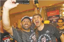  ?? PATRICK SEMANSKY/ASSOCIATED PRESS ?? The Nationals’ Ryan Zimmerman, right, and Dr. Hirad Bagy celebrate after Game 4 of the National League Championsh­ip Series against the Cardinals on Wednesday in Washington. The Nationals won 7-4 to win the series 4-0.