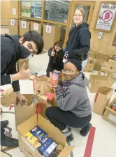  ?? HIGH SCHOOL DISTRICT 228 ?? Bremen High School students Noe Rangel, Flor Santos Molina, Kiera Boos and Zelena Campbell unpack donations from the community during week three of the food drive.