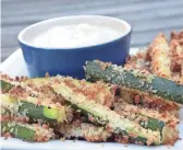  ?? BRENTON GOSPODAREK ?? No one will miss the potatoes with these crunchy baked zucchini fries.