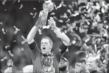  ?? Darron Cummings Associated Press ?? NEW ENGLAND Patriots quarterbac­k Tom Brady hoists the Vince Lombardi Trophy after his team’s comeback win over the Atlanta Falcons in last year’s Super Bowl. The Fox broadcast averaged 111.3 million viewers.