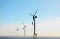  ?? SUZIE HOWELL/THE NEW YORK TIMES ?? Wind turbines off the coast of East Anglia in England, which had installed more offshore wind turbines than any other country by 2021.