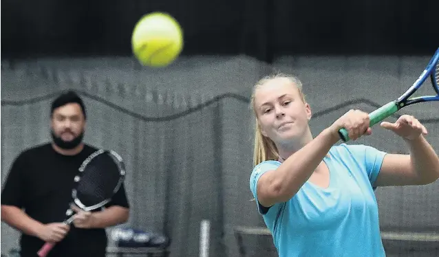  ?? PHOTO: PETER MCINTOSH ?? New faces . . . Ivy McLean, watched by Jaden Grinter, hits the ball at the Edgar Centre in Dunedin yesterday.