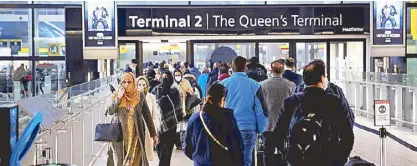  ?? REUTERS ?? File photo shows people lining up to enter terminal 2 at Heathrow Airport in London amid the COVID-19 pandemic.
