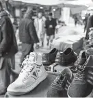  ??  ?? A knockoff Servis sneaker is for sale this month at a bazaar in Mazar-i-Sharif, Afghanista­n.