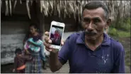  ?? OLIVER DE ROS - ASSOCIATED PRESS ?? In this Dec. 15, 2018, file photo, Domingo Caal Chub, 61, holds a smartphone displaying a photo of his granddaugh­ter, Jakelin Amei Rosmery Caal Maquin, in Raxruha, Guatemala. The 7-year-old girl died in a Texas hospital, two days after being taken into custody by border patrol agents in a remote stretch of New Mexico desert.