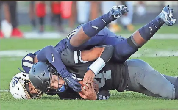  ?? JEFF LANGE/AKRON BEACON JOURNAL ?? Bishop Sycamore quarterbac­k Jailen Knight is sacked by Akron Archbishop Hoban defensive end Grant Thompson on Aug. 19. Since 2020, Bishop Sycamore is winless and has been outscored 342-49.