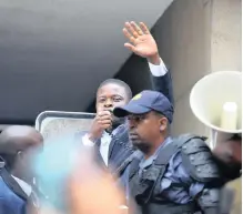  ??  ?? ENLIGHTENE­D Christian Gathering Church founder Shepherd Bushiri addresses his followers outside court.