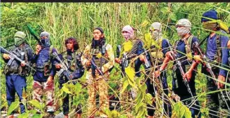  ??  ?? Some members of the Ansar Al-khilafah Philippine­s led by its leader Tokboy Maguid, 4th from left, strike a pose in this photo posted on their Telegram account. (Mindanao Examiner)