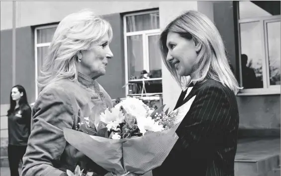  ?? AP PHOTO/SUSAN WALSH, POOL ?? First lady Jill Biden greets Olena Zelenska, spouse of Ukrainian’s President Volodymyr Zelenskyy, outside of School 6, a public school that has taken in displaced students in Uzhhorod, Ukraine, on Sunday.