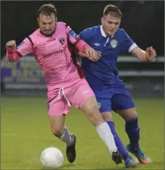  ??  ?? Peter Higgins of Wexford Youths holding off Ger Pender (Cabinteely).