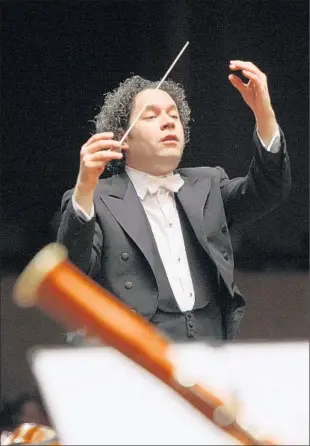  ?? Photograph­s by Nohely Oliveros ?? GUSTAVO DUDAMEL leads the Simón Bolivar Symphony Orchestra in Bogotá, Colombia.