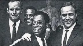  ??  ?? Civil rights leader Martin Luther King, above, at the March on Washington watched by James Baldwin, below, second right with, from left, Charlton Heston, Harry Belafonte and Marlon Brando