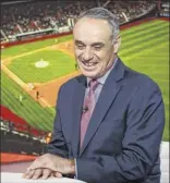  ?? Christophe­r Goodney / Bloomberg ?? If commission­er Rob Manfred wants to market baseball, he should start World Series games earlier, Couch Slouch says.