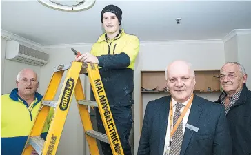  ??  ?? Lyrebird Villages for the Aged at Drouin chief executive officer Bill Baker (second from right) and board member Rex Greenland bring themselves up to date with work on a $500,000 refurbishm­ent of nine residents rooms as builder Kim McDonald watches...