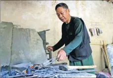  ?? HUO YAN / CHINA DAILY ?? Liang Yuqian, 70, at work in the blacksmith’s workshop in Liangjiahe that Xi proposed setting up in 1974.