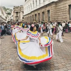  ??  ?? PLACES TO GO: Tropical sky above a fort in Mozambique. Dancers in Quito, Ecuador. Below, canal in Amsterdam.