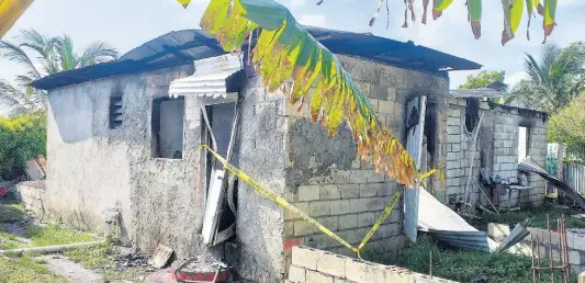  ?? PHOTO BY GARETH DAVIS SR ?? The Buff Bay, Portland, house in which Maureen Johnson lived, which was set on fire after she was stabbed to death on Tuesday night.