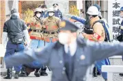  ?? ?? ON A KNIFEEDGE: Police and rescue workers inspect the site of a stabbing incident at an entrance gate of Tokyo University in Japan yesterday.