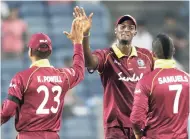  ?? AP ?? West Indies captain Jason Holder (centre) celebrates with teammates after their win in the third one-day internatio­nal cricket match against hosts India in Pune yesterday.