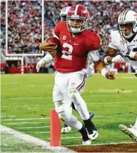  ??  ?? Auburn defensive back Tray Matthews pushes Alabama quaarterba­ck Jalen Hurts as he runs in for a touchdown during the first half of the Iron Bowl.