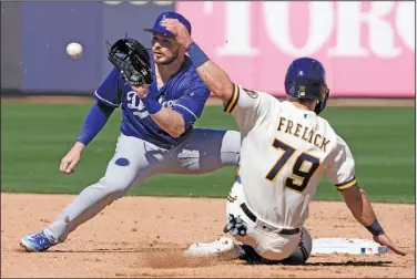  ?? Associated Press ?? Play at second: Los Angeles Dodgers' Gavin Lux tags out Milwaukee Brewers' Sal Frelick at second on a stolen base attempt during the second inning of a spring training baseball game Saturday in Phoenix.