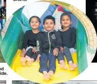  ??  ?? RIGHT: Jasleen Kaur, left, Yuvraj Singh and Avleen Kaur on the bouncy monster slide. A spectacula­r display ended the night at Fairhaven School’s Thinkwater Fireworks Gala.