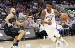  ?? JOHN RAOUX — THE ASSOCIATED PRESS ?? Philadelph­ia 76ers’ guard Jimmy Butler (23) drives the lane past the Orlando Magic’s Evan Fournier during the first half of Wednesday’s game.