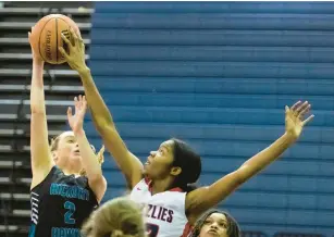  ?? BILLY SCHUERMAN/STAFF ?? Grassfield’s Gabby Morris, right, blocks a shot by Hickory’s Charlotte Patchet in the Grizzlies’ 76-46 victory earlier this month. Morris’ 120 blocks so far place her fifth for a single season on the state high school list. She has 301 career blocks.