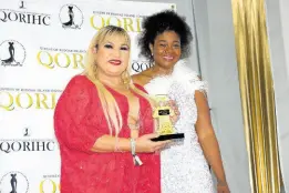  ?? ?? Carlene Smith (left) receives a QORIHC trophy in honour of her late sister, Pinky, from founder Laurell Nurse.