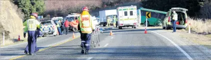  ?? PHOTO: JONO EDWARDS ?? Fatal collision . . . Emergency services attend a crash between a ute and a tourist bus near Roxburgh yesterday.