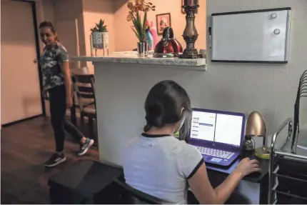  ??  ?? Jacqueline Aviña, 15, checks her homework as her mother, Alma Vargas, does chores in May.