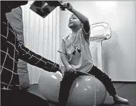  ?? TERRENCE ANTONIO JAMES/CHICAGO TRIBUNE ?? Jaxtien Miller receives physical therapy in Quincy, Illinois, on Nov. 4. The therapy is intended to help him maintain his muscle strength.