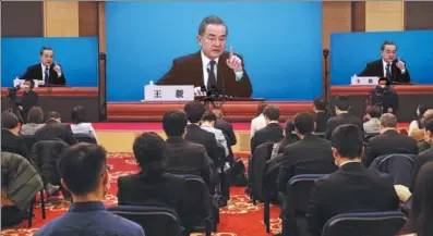  ?? WANG JING / CHINA DAILY ?? State Councilor and Foreign Minister Wang Yi answers questions about China’s foreign policy and external relations at a virtual news conference on Sunday in Beijing during the fourth session of the 13th National People’s Congress, China’s top legislatur­e.