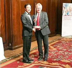  ??  ?? ha (left) receiving the sword of honour from the british safety Council’s chief executive, mike robinson - a first for malaysia’s constructi­on industry.