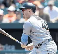  ?? GAIL BURTON/AP ?? Marlins’ first baseman Justin Bour had two home runs and drove in four runs on Sunday against Baltimore.